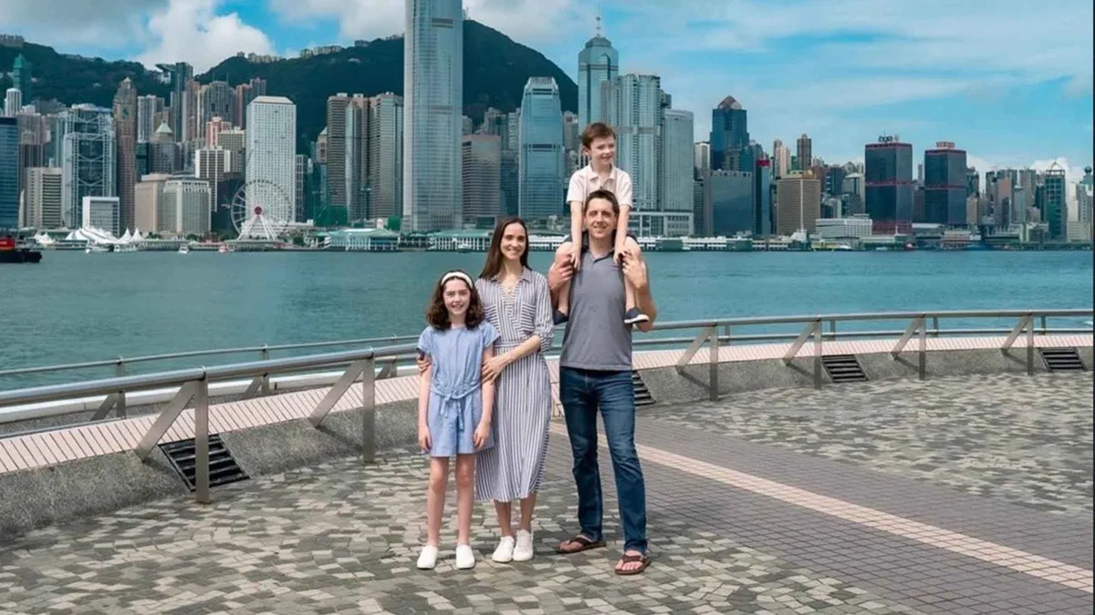 Family photographed among colourful tenement facades in Central during a private Hong Kong photoshoot with a travel photographer